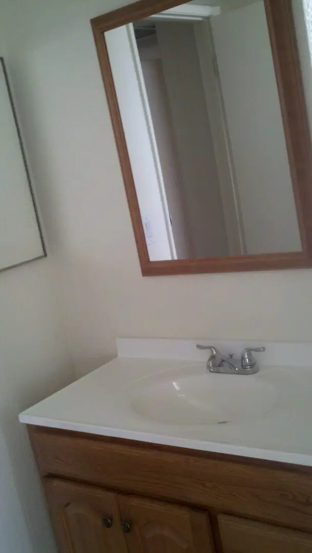 A clean bathroom sink with a mirror above it.