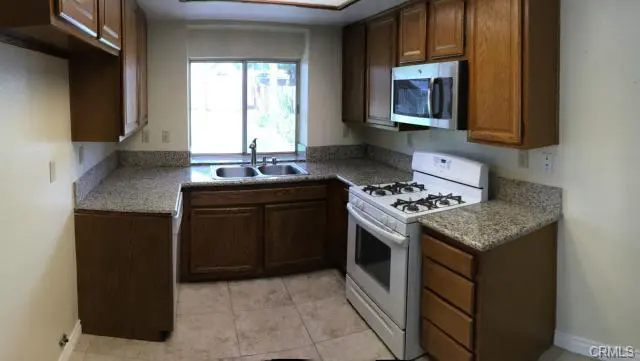 Modern kitchen with wooden cabinets and a gas stove.