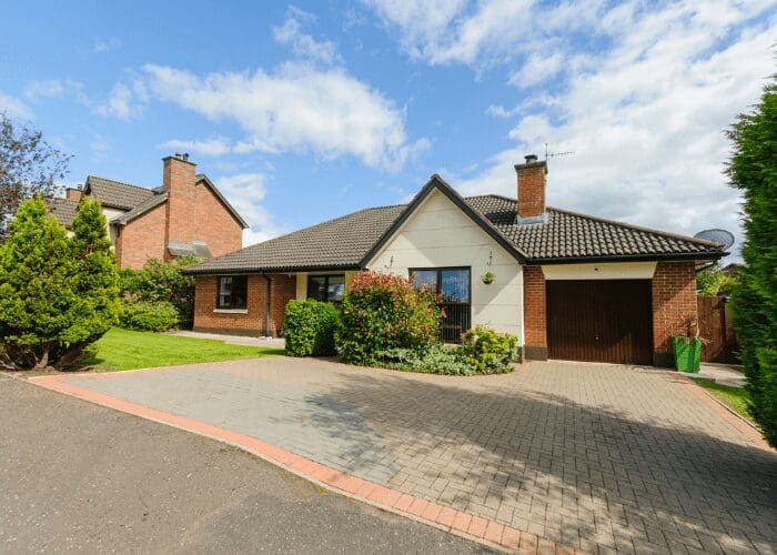 Suburban house with garden and driveway.