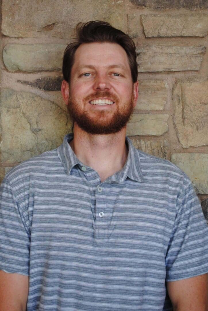 Smiling bearded man wearing a striped polo