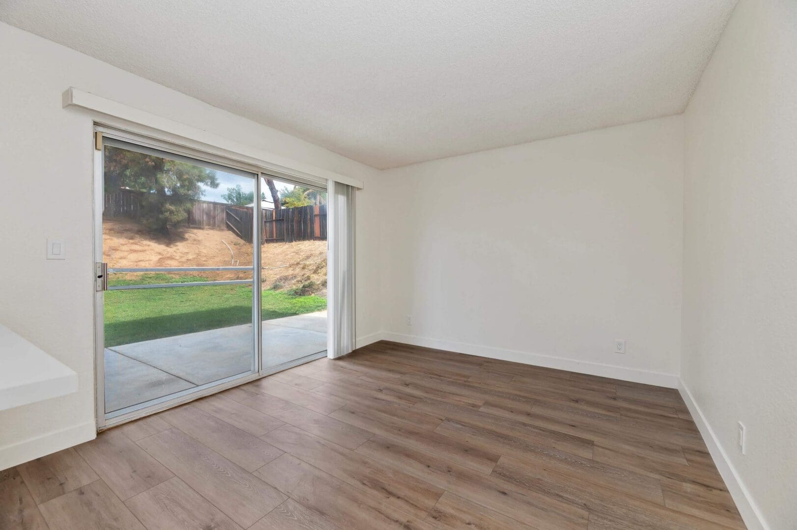 Empty room with sliding glass door.