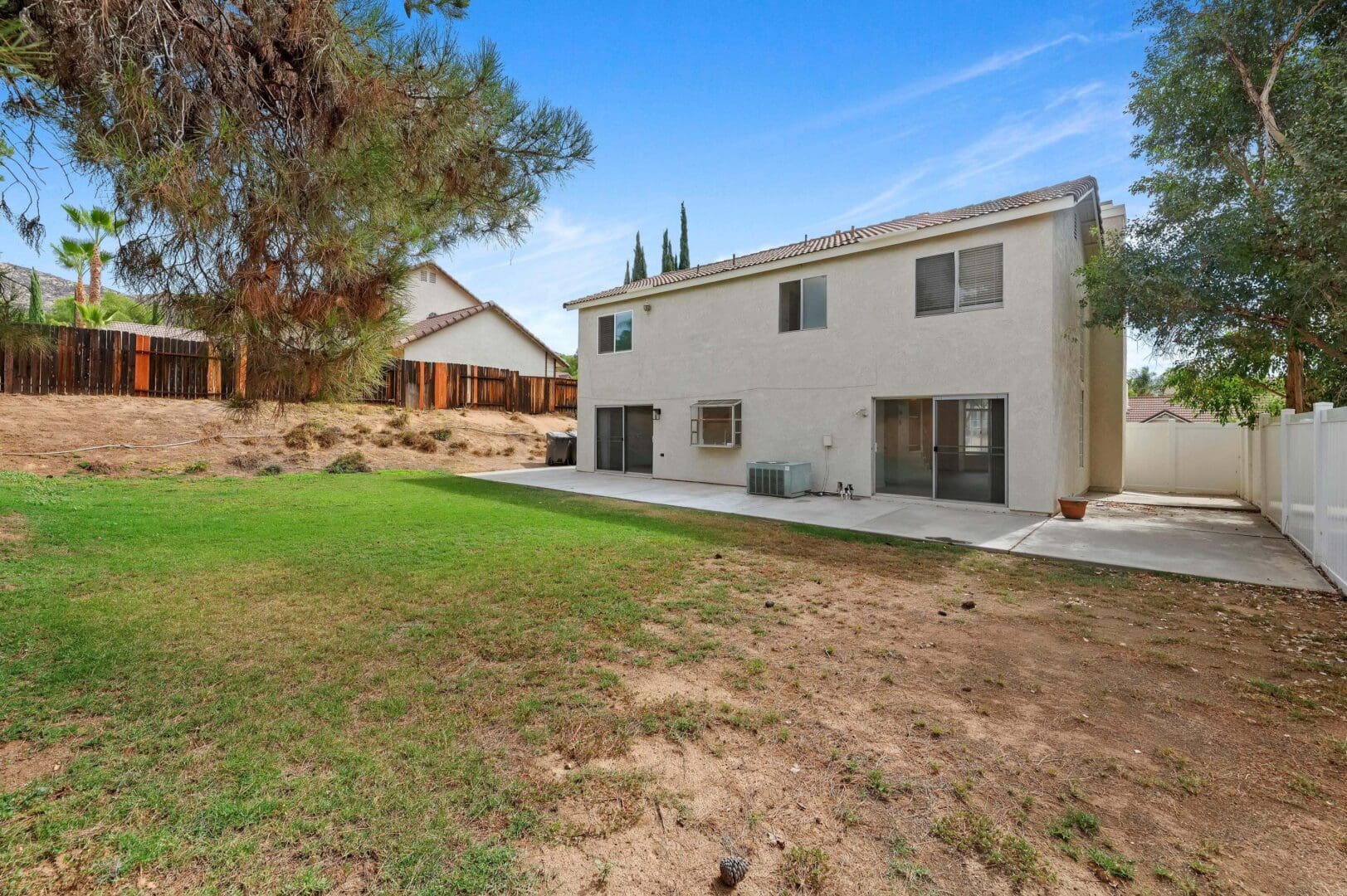 Backyard view of a two-story house.