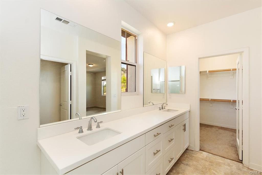 Modern bathroom with double sinks and mirrors.