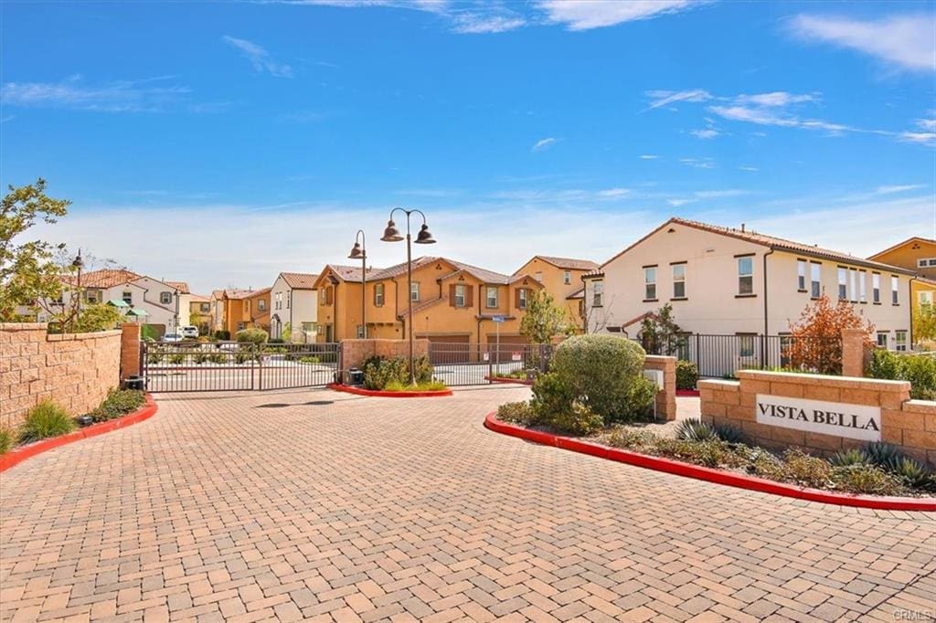 Gated residential community with landscaped entrance.