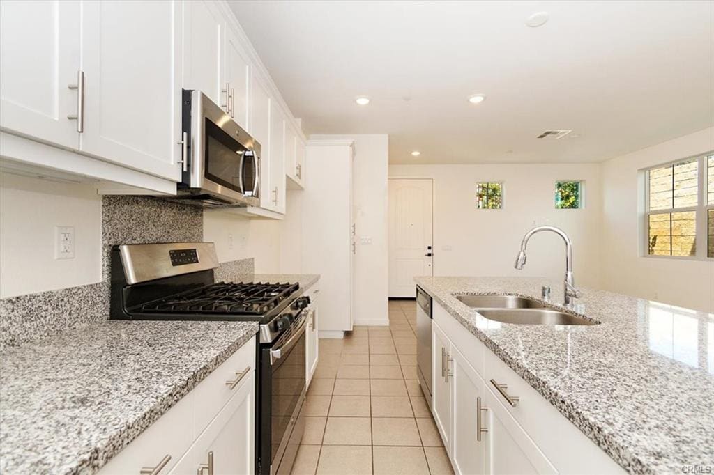 Modern kitchen with granite countertops and appliances.