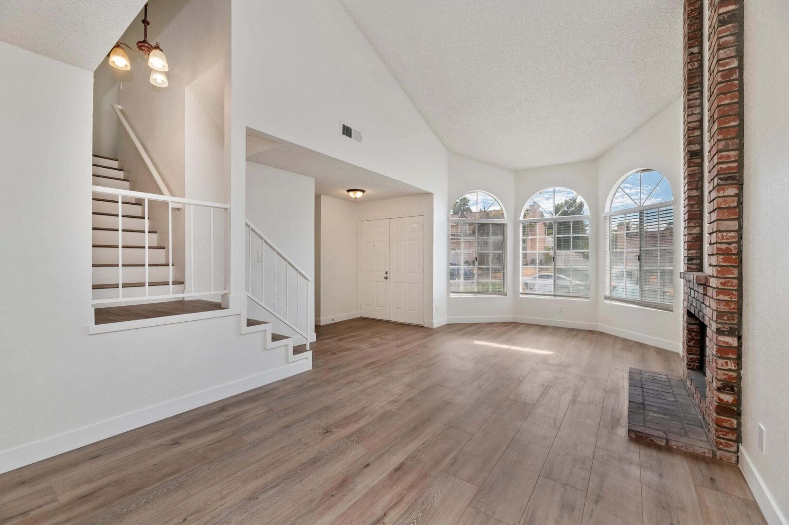 Spacious living room with large windows.