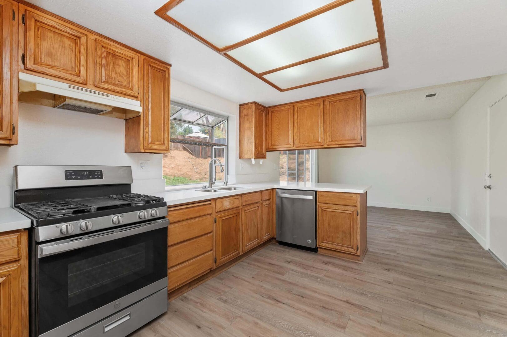 Modern kitchen with wooden cabinets and appliances.