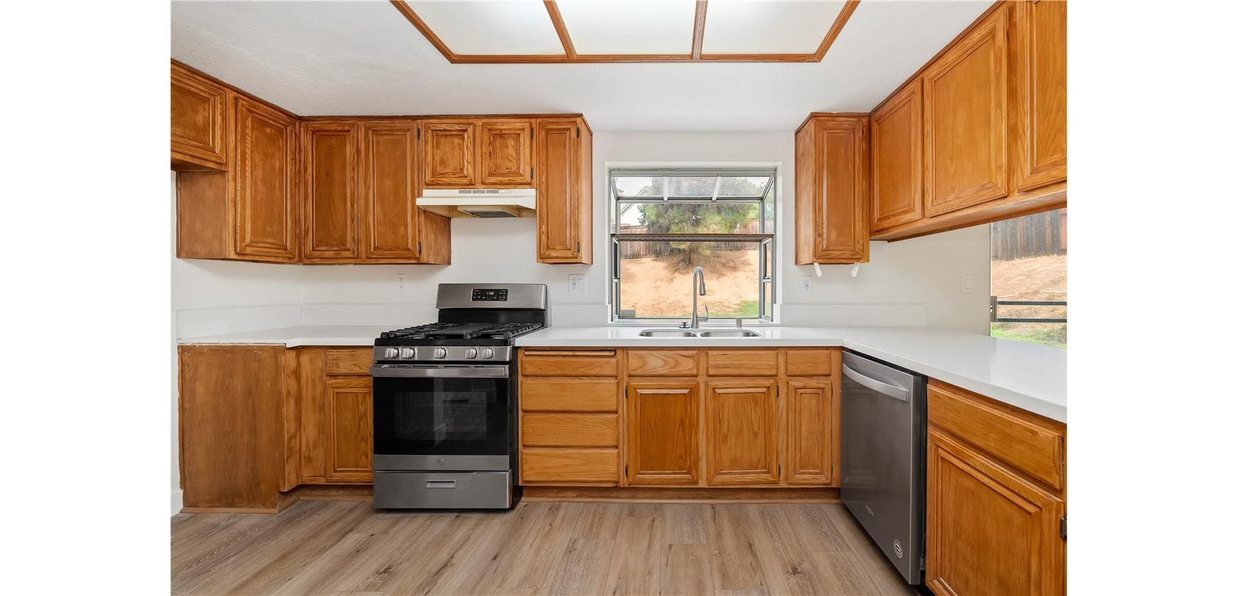 Spacious kitchen with wooden cabinets and appliances.