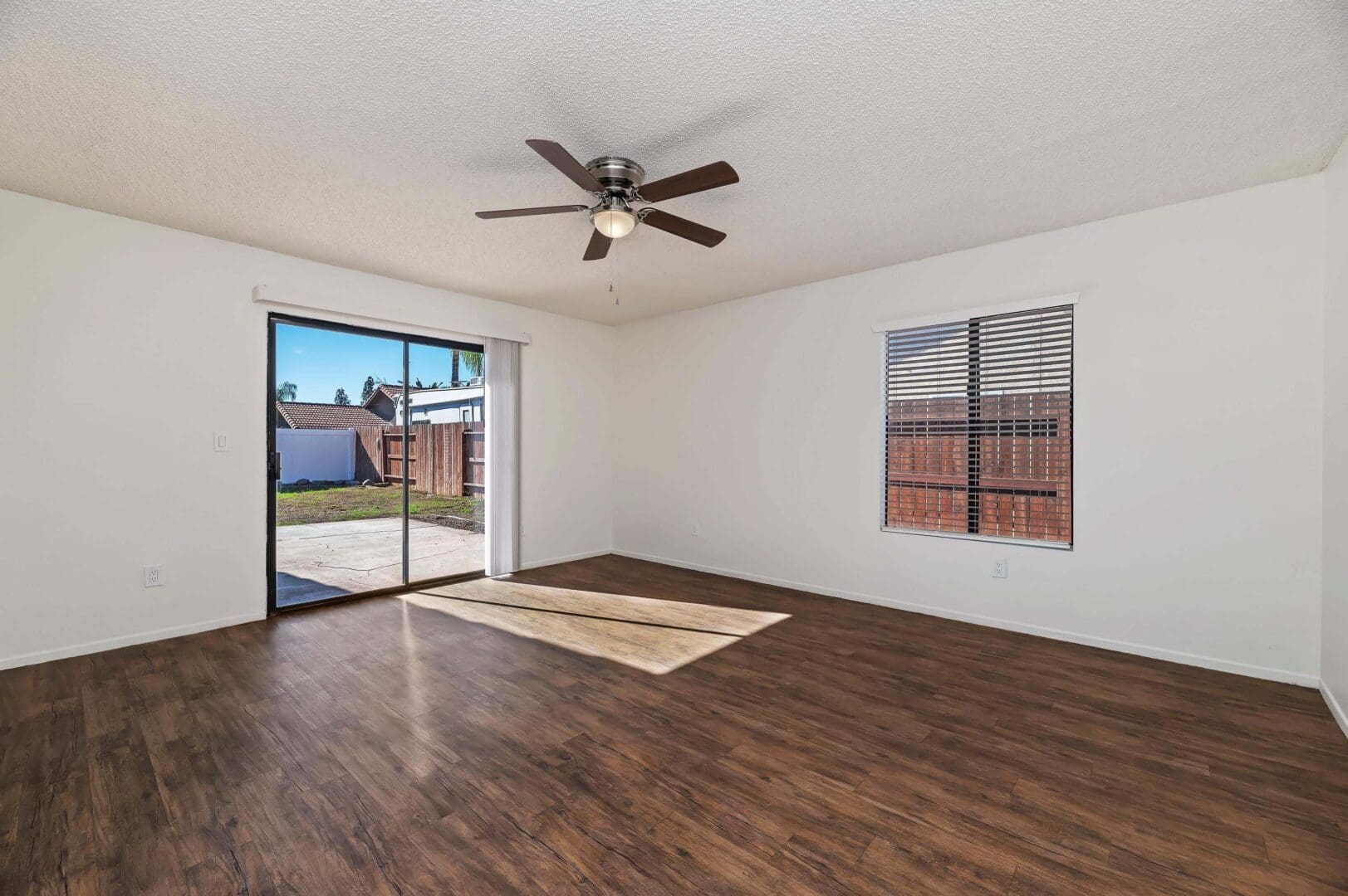 Empty room with wooden floor and window.