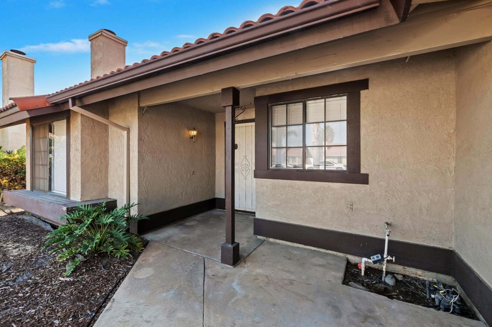House entrance with covered porch and window.